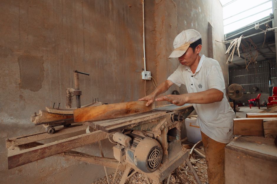 Master carpenter working on custom kitchen cabinets in a woodshop